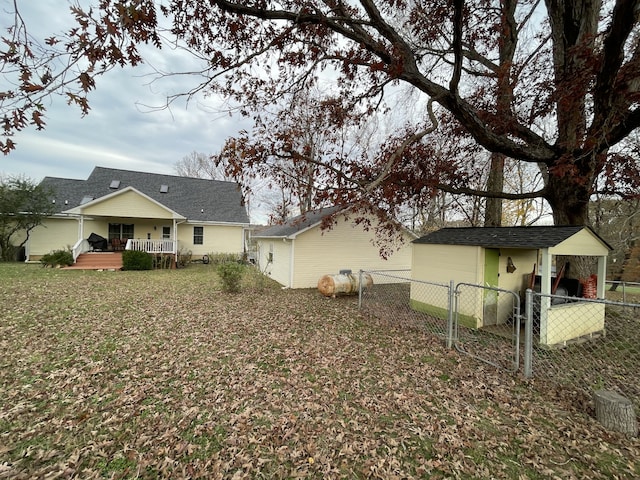 rear view of property with a lawn and a porch