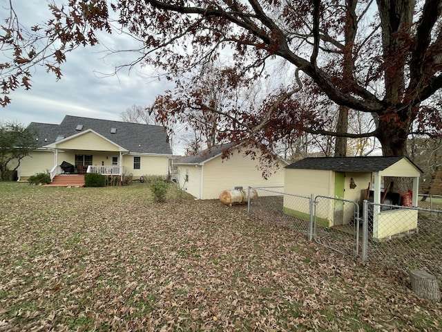 314 Birdsong Dr, Cadiz, KY 42211 - back of property featuring a deck, a gate, and an outdoor structure