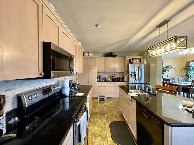314 Birdsong Dr, Cadiz, KY 42211 - kitchen with stainless steel appliances, an island with sink, decorative backsplash, decorative light fixtures, and dark stone counters