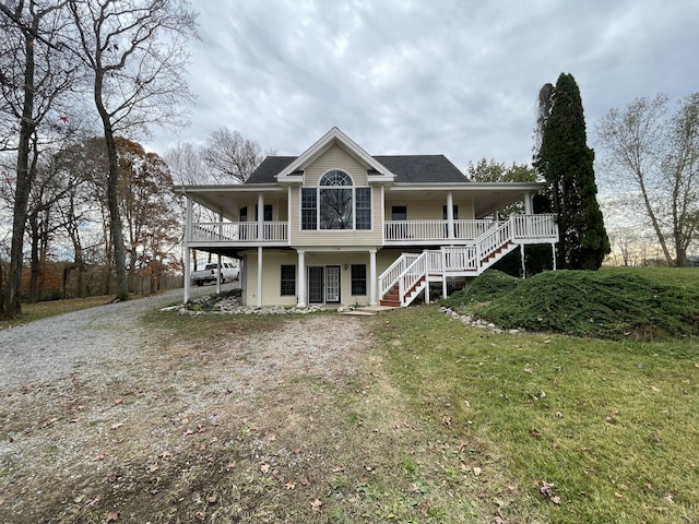 back of house with a yard and covered porch