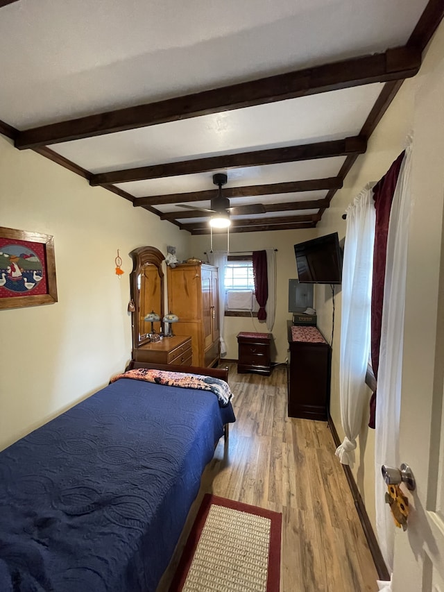 bedroom featuring ceiling fan, beamed ceiling, and light hardwood / wood-style floors