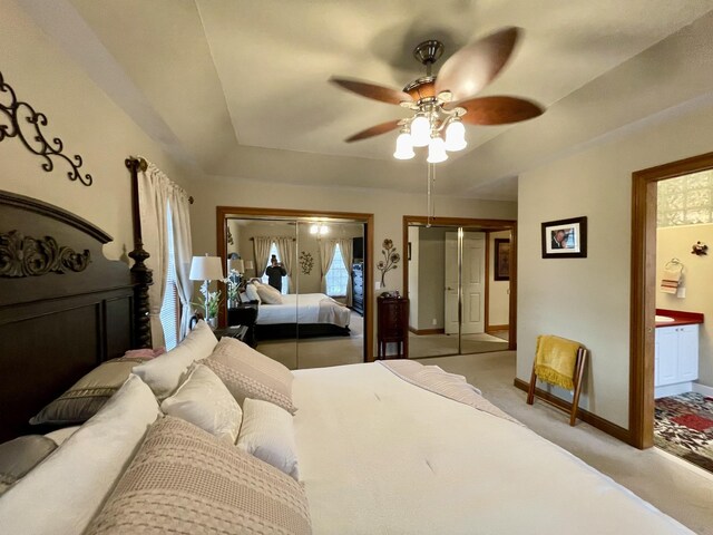 314 Birdsong Dr, Cadiz, KY 42211 - bedroom with light colored carpet, a raised ceiling, connected bathroom, ceiling fan, and two closets