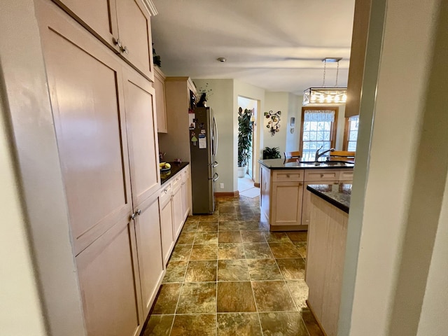 314 Birdsong Dr, Cadiz, KY 42211 - kitchen featuring freestanding refrigerator, dark countertops, dark stone finish flooring, pendant lighting, and a peninsula