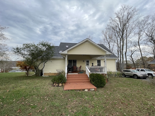 view of front of home featuring covered porch and a front yard