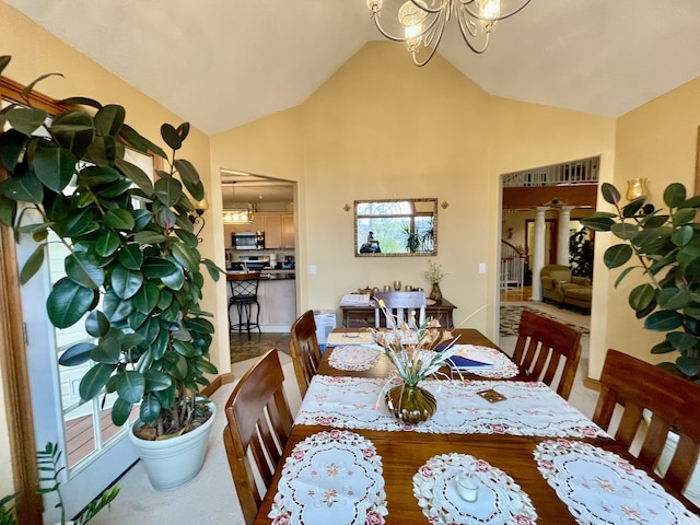 dining room with high vaulted ceiling and an inviting chandelier