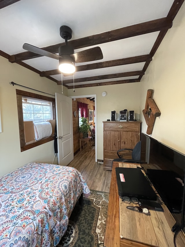 bedroom featuring beam ceiling, ceiling fan, and light hardwood / wood-style floors