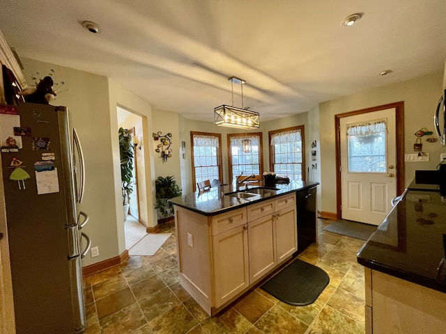 kitchen with dishwasher, sink, hanging light fixtures, stainless steel fridge, and a center island with sink