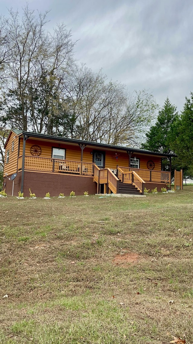 314 Birdsong Dr, Cadiz, KY 42211 - view of front of property featuring a wooden deck, a front lawn, and faux log siding