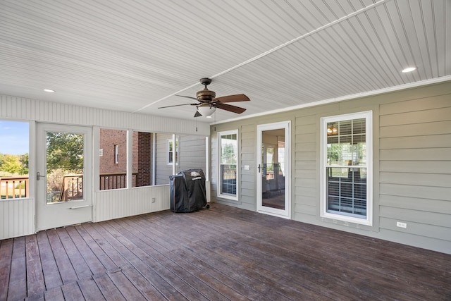 unfurnished sunroom featuring ceiling fan