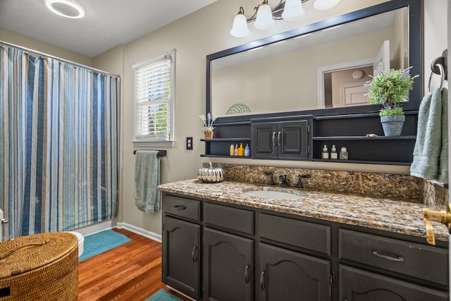 bathroom featuring hardwood / wood-style flooring, vanity, and a shower with curtain