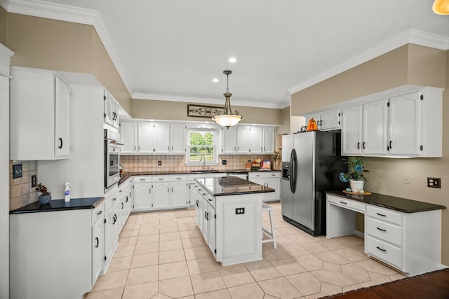 kitchen with a sink, stainless steel oven, refrigerator with ice dispenser, white cabinetry, and dark countertops