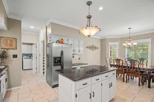 kitchen featuring washer / clothes dryer, stainless steel fridge, white cabinets, and pendant lighting