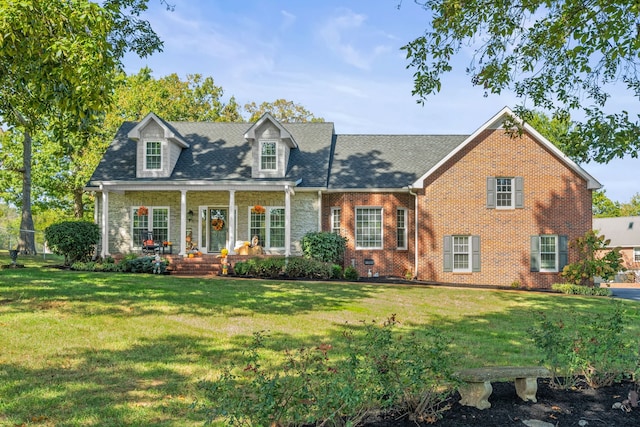 new england style home with a porch and a front yard