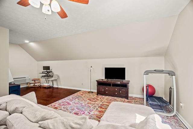 living room featuring a wall mounted air conditioner, ceiling fan, wood-type flooring, and vaulted ceiling