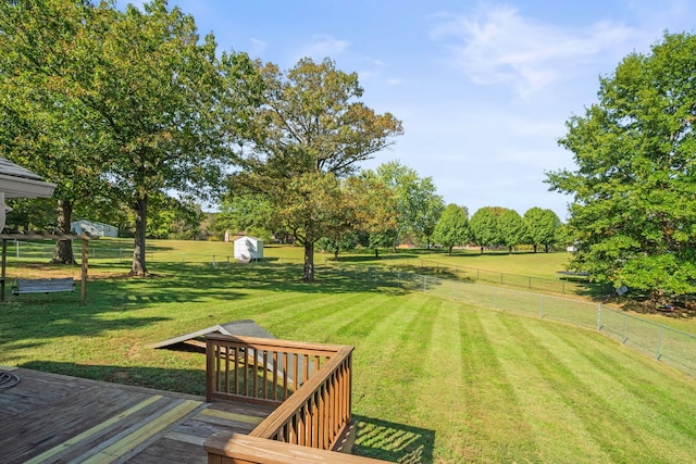 view of yard featuring fence and a wooden deck