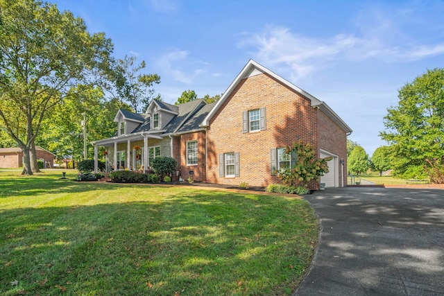 view of front of property featuring a garage and a front lawn