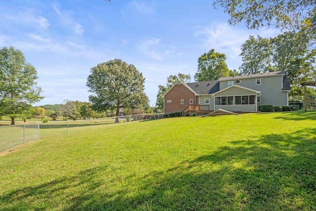 view of yard with a deck and a sunroom