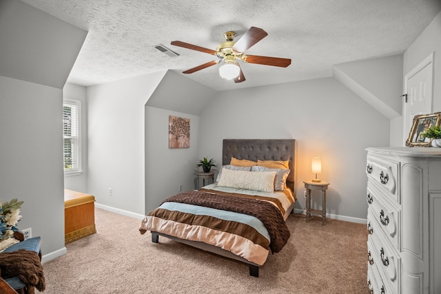 bedroom featuring carpet floors, visible vents, a ceiling fan, vaulted ceiling, and baseboards