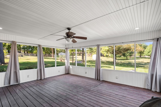 unfurnished sunroom with ceiling fan