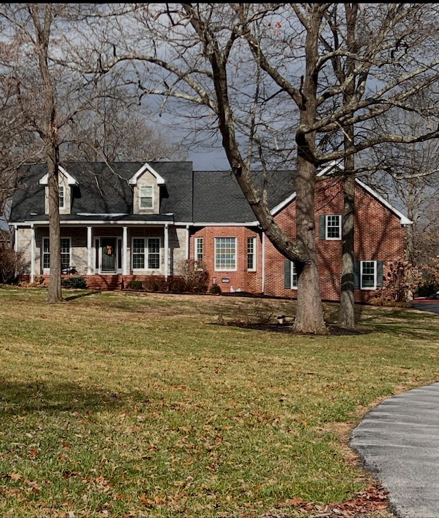 new england style home with a front lawn