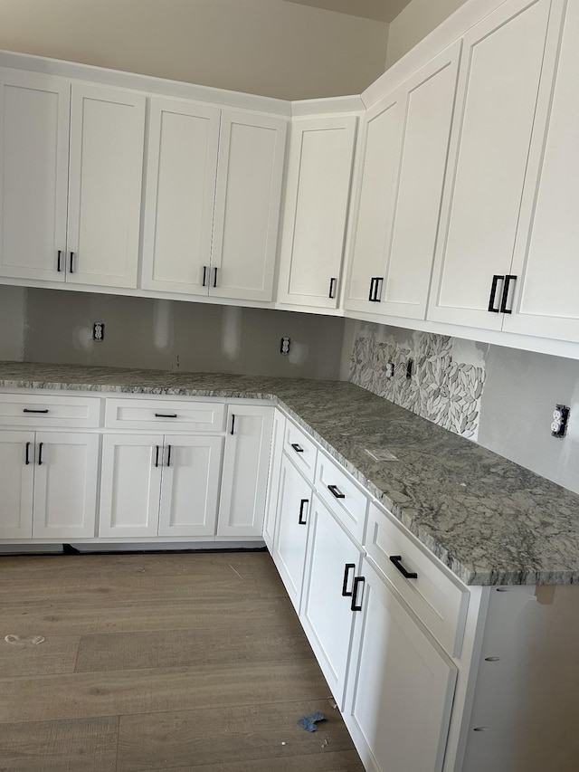 kitchen featuring dark wood-style floors and white cabinets