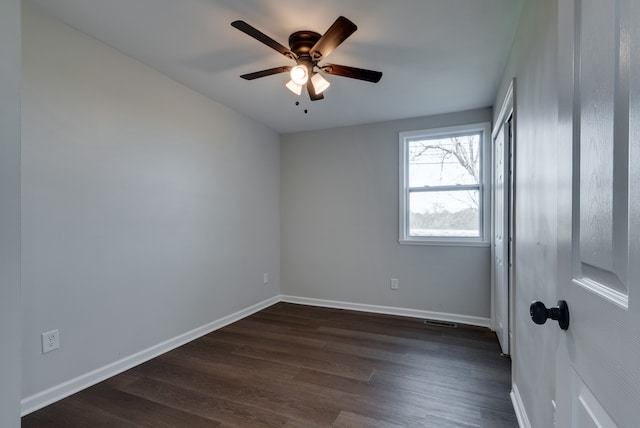 spare room featuring ceiling fan and dark hardwood / wood-style flooring