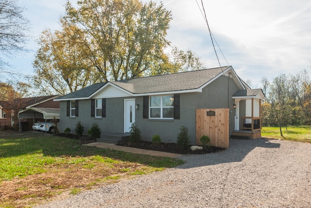 single story home featuring a carport and a front yard