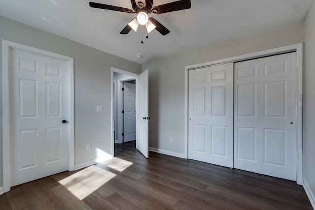 unfurnished bedroom with ceiling fan, a closet, and dark hardwood / wood-style floors