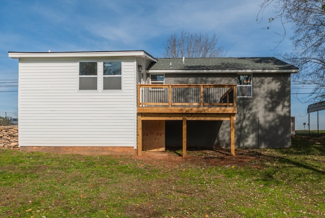 rear view of property with a deck and a yard