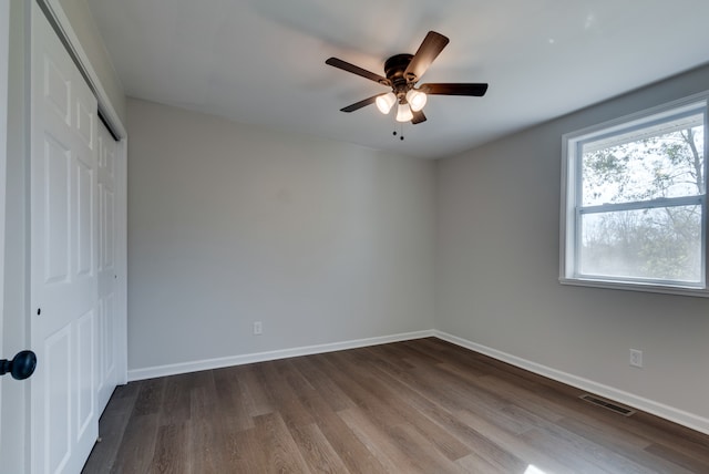 unfurnished bedroom with ceiling fan and wood-type flooring