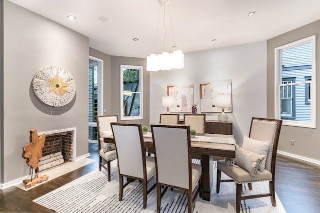 dining space with dark wood-type flooring and a healthy amount of sunlight