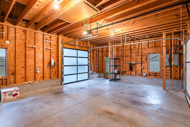 garage featuring electric panel and a garage door opener