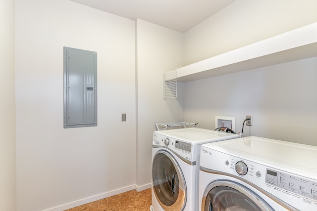 clothes washing area featuring electric panel and independent washer and dryer