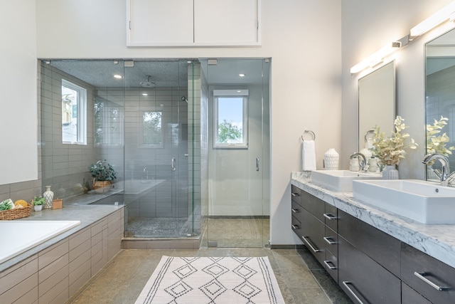 bathroom with tile patterned flooring, vanity, and an enclosed shower