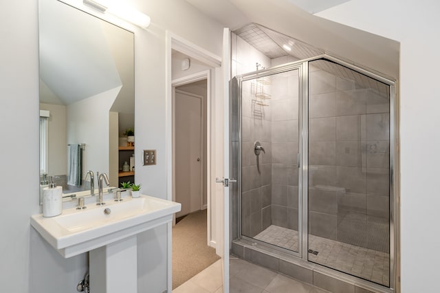 bathroom featuring tile patterned floors, a shower with shower door, and sink