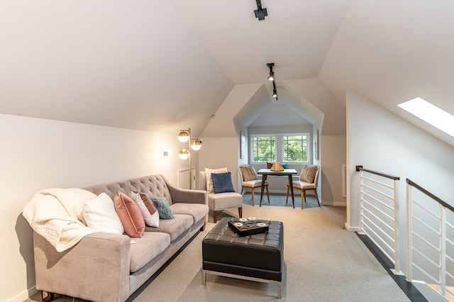 living room featuring vaulted ceiling with skylight and carpet