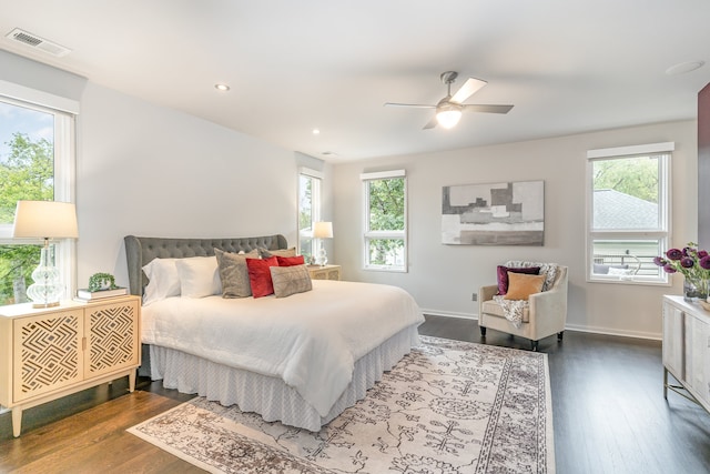 bedroom featuring multiple windows, ceiling fan, and hardwood / wood-style floors