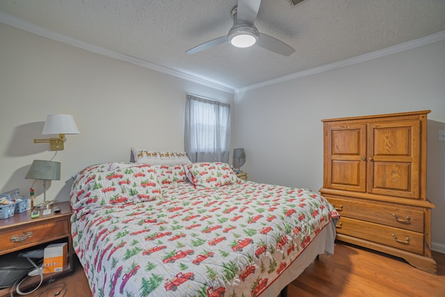 bedroom with ceiling fan, crown molding, hardwood / wood-style floors, and a textured ceiling