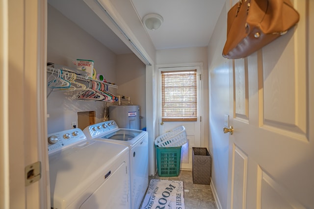 clothes washing area with water heater, light tile patterned flooring, and washer and dryer