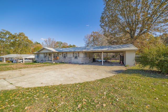 view of front facade with a front lawn and a carport