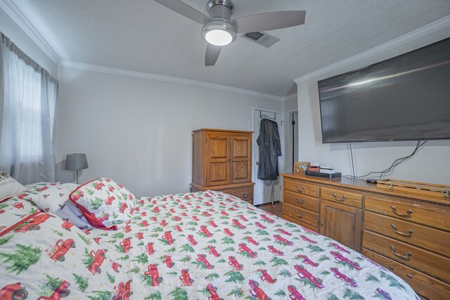 bedroom with ceiling fan and crown molding