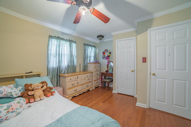 bedroom featuring light hardwood / wood-style flooring, ceiling fan, and ornamental molding