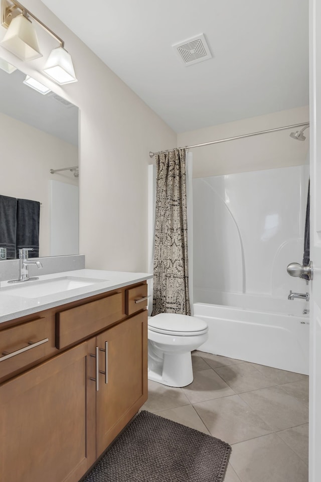 full bathroom with tile patterned flooring, vanity, shower / bath combo, and toilet