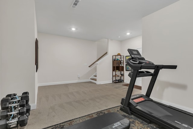 exercise room featuring light colored carpet