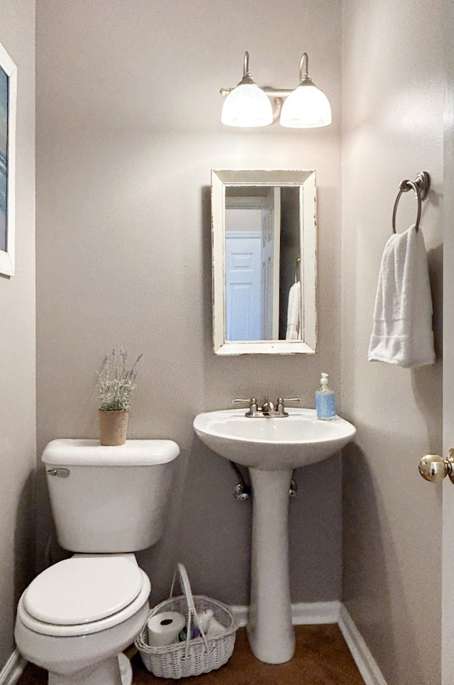 bathroom featuring toilet and sink