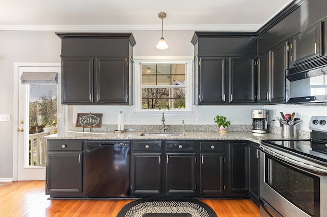 kitchen featuring black appliances, light hardwood / wood-style floors, sink, and tasteful backsplash