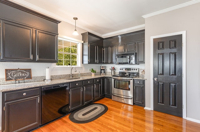 kitchen featuring black appliances, sink, light wood-type flooring, ornamental molding, and decorative light fixtures