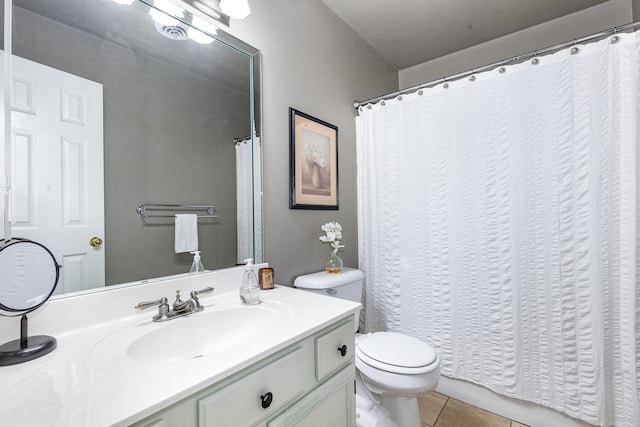 bathroom featuring tile patterned flooring, vanity, and toilet