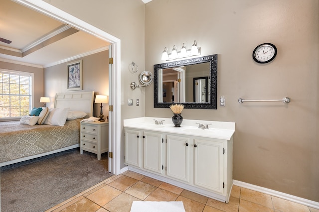 bathroom featuring tile patterned floors, vanity, a raised ceiling, and ornamental molding