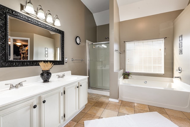 bathroom with independent shower and bath, vanity, tile patterned floors, and lofted ceiling